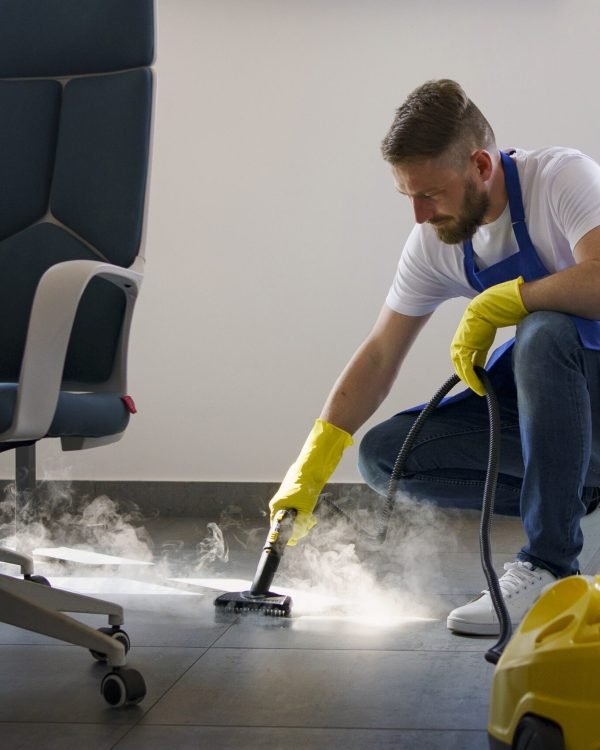 professional-cleaning-service-person-using-steam-cleaner-office